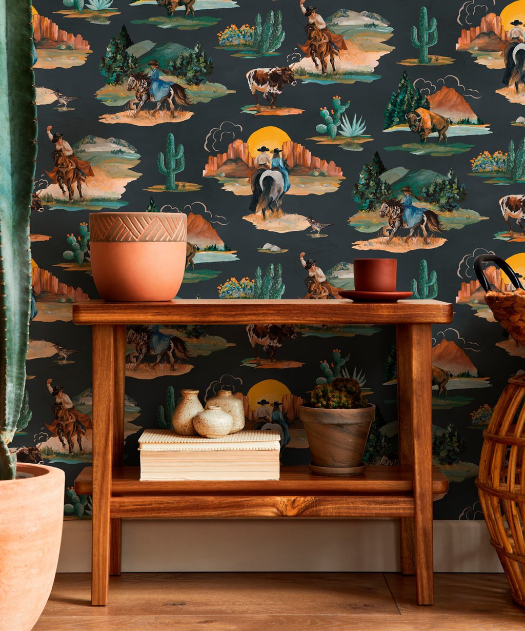 Rustic wooden shelf against western wallpaper featuring cowboys, horses, and desert cactus scenery.