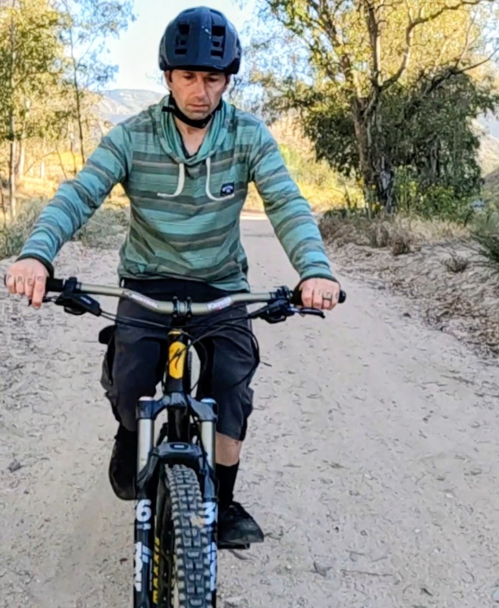 Mountain biker not wearing gloves on a hot morning ride.