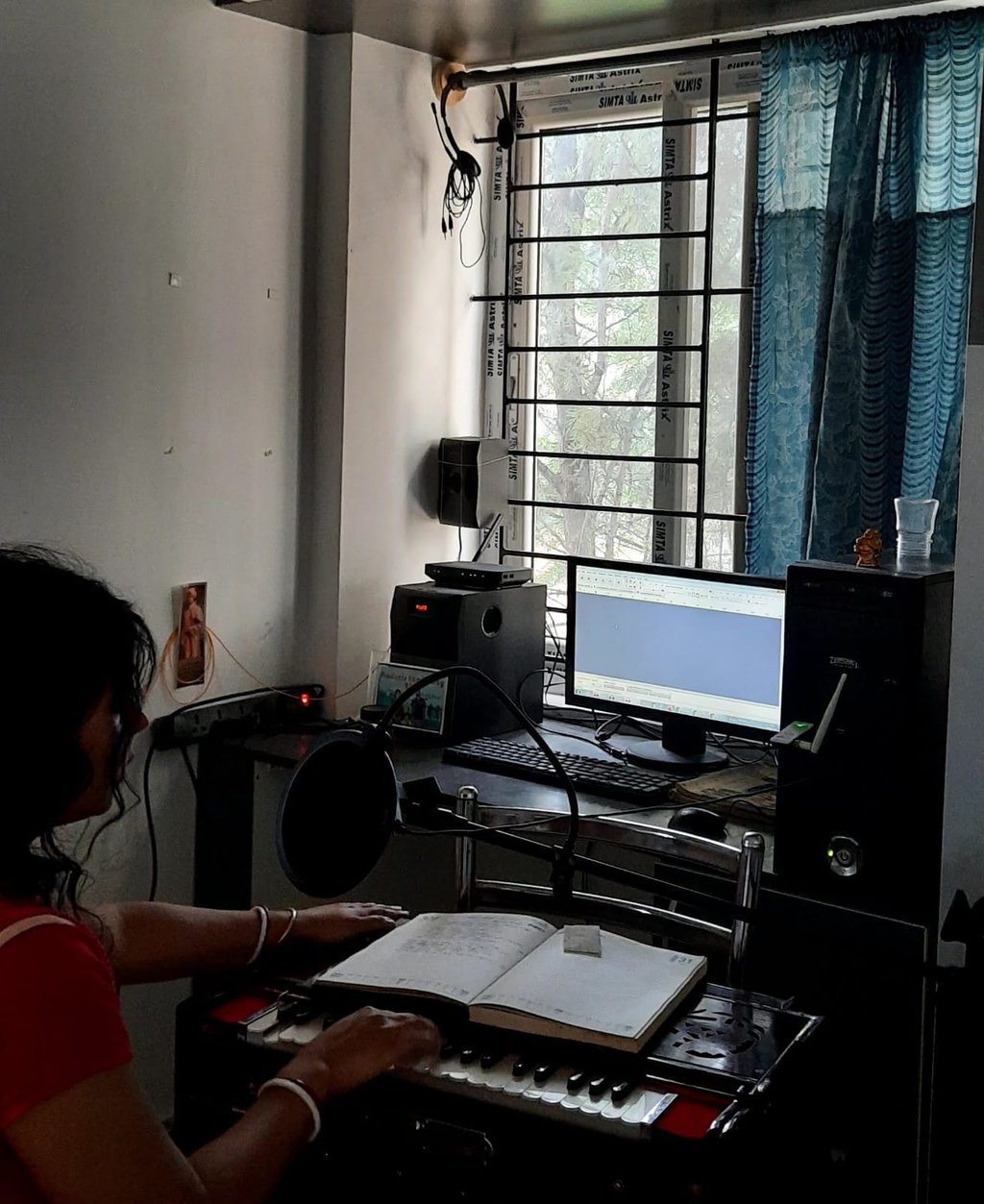 a woman sitting at a desk with a keyboard and a keyboard