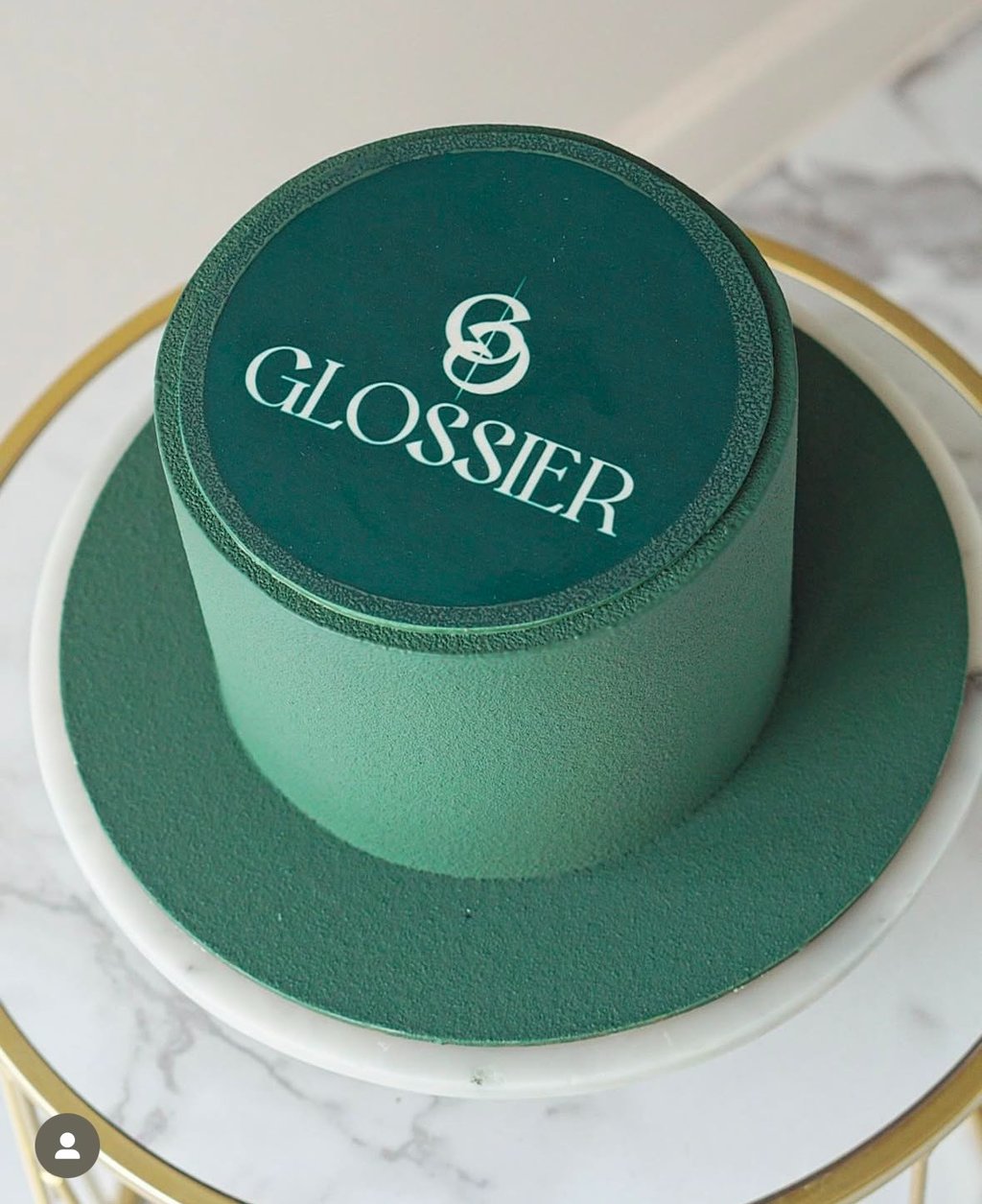 a cake with a green hat on top of a table