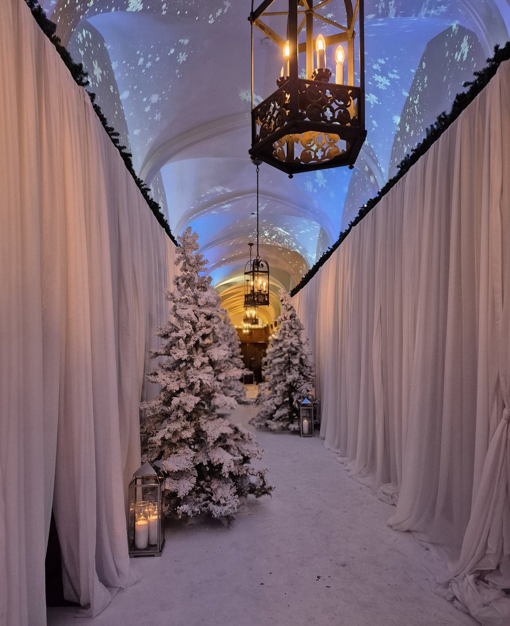 fir tree with fake snow and candles in hallway of castle