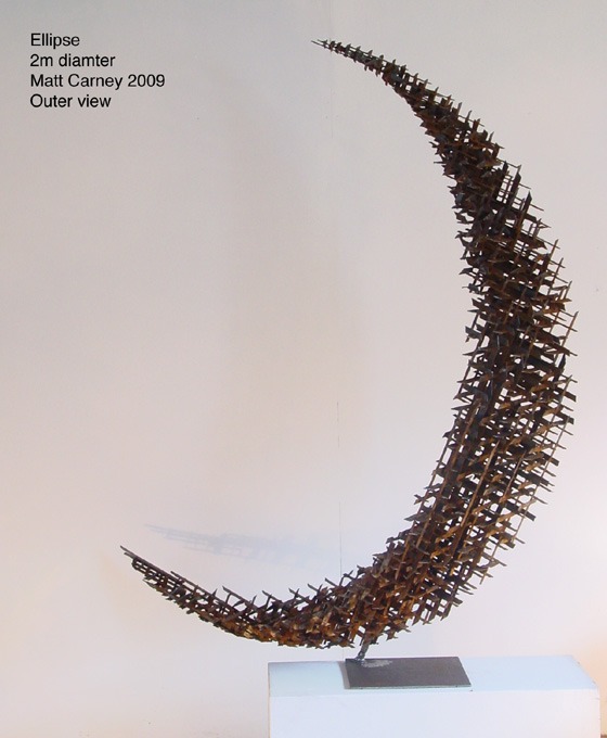 a rusted steel cross-hatched crescent shaped sculpture