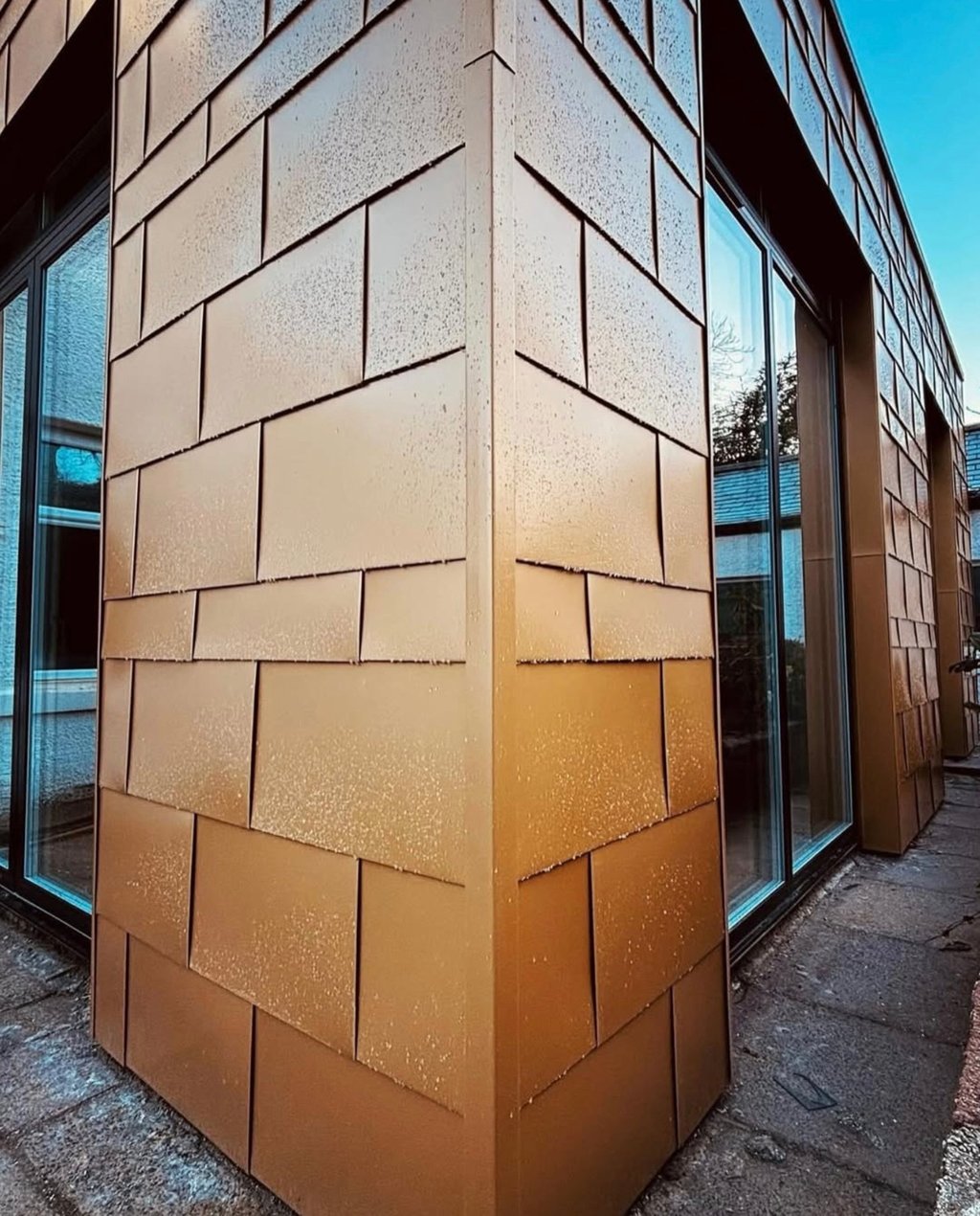 Modern building exterior featuring bronze architectural metal rainscreen cladding panels.