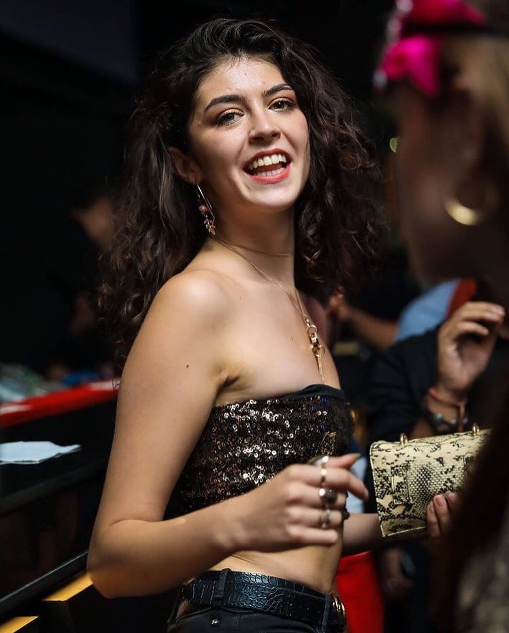 a woman in a sequinous top and jeans