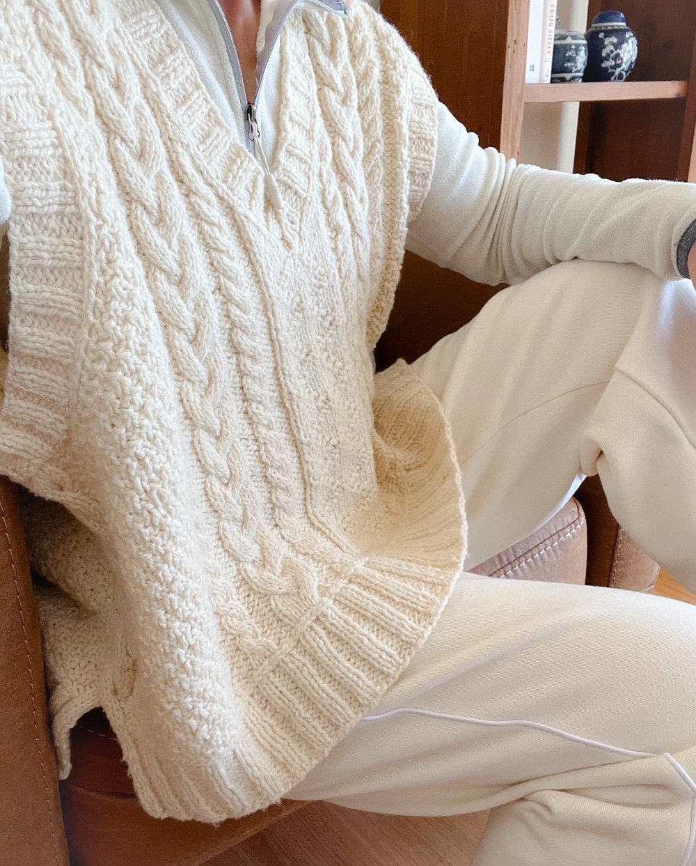 Close up of a Marie, founder of Paddock and Purl Studio in a cream cable slipover. 