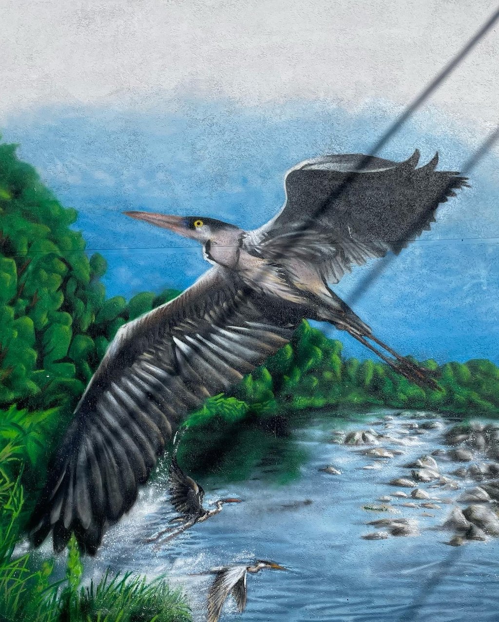 une peinture de héron cendré