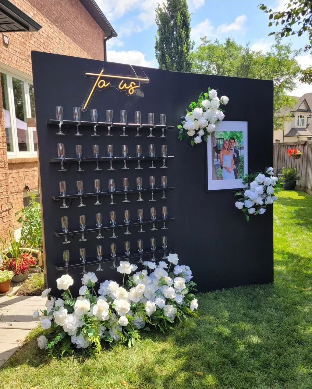 Black champagne wall package with a side panel of a photo of the bride and groom