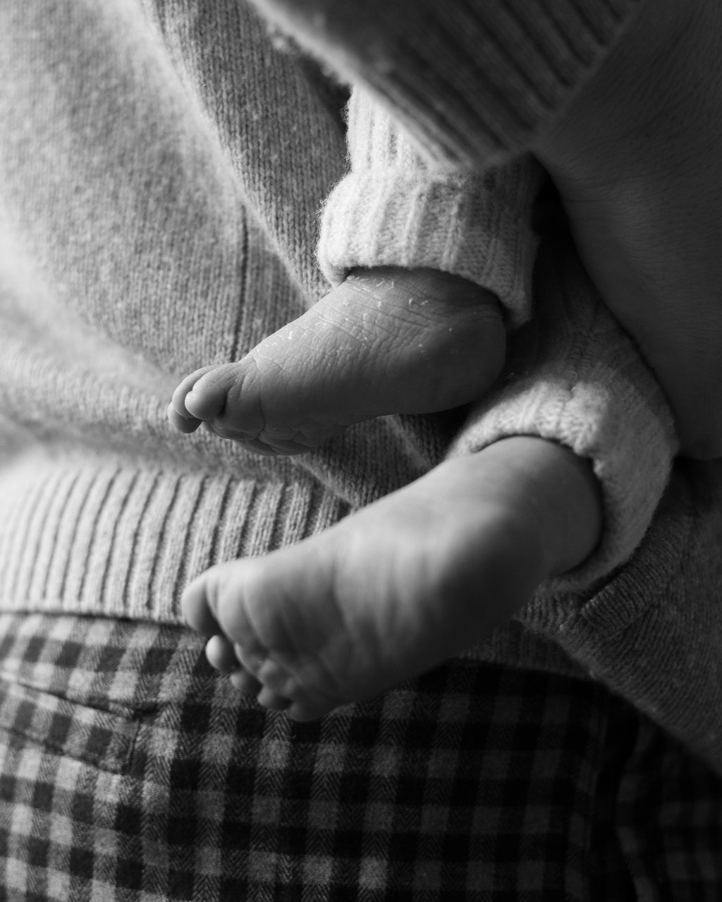 black and white image of newborn's feet