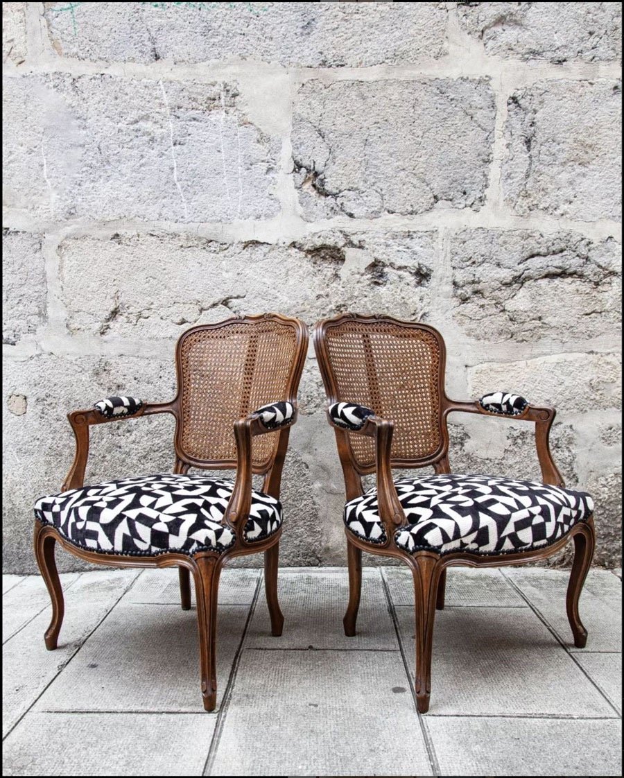 two chairs with a black and white patterned seat