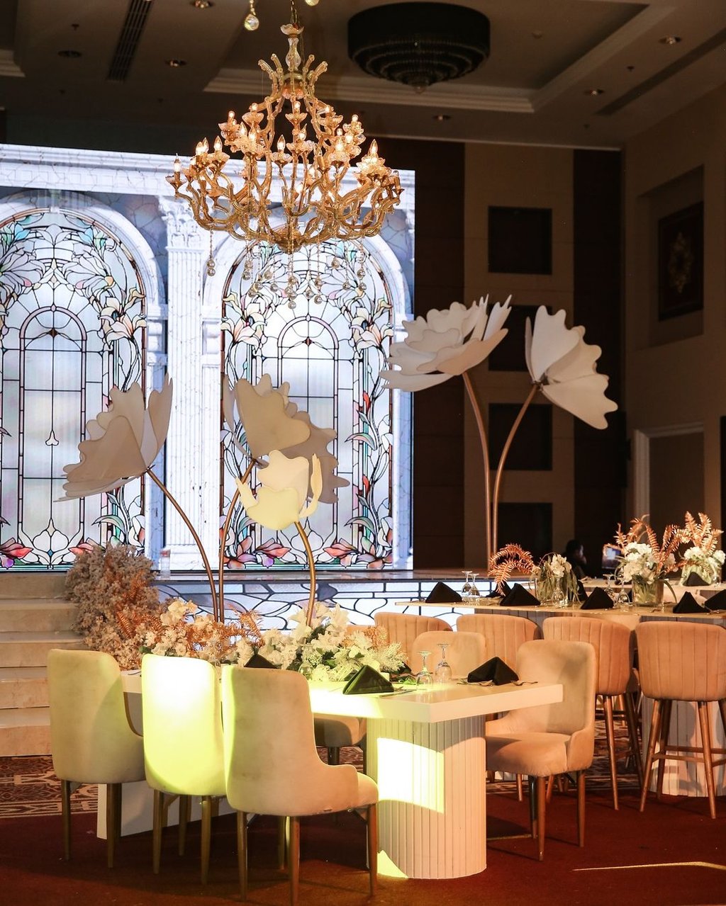 a large table in the front with a led screen in the back of an arches and stained glass