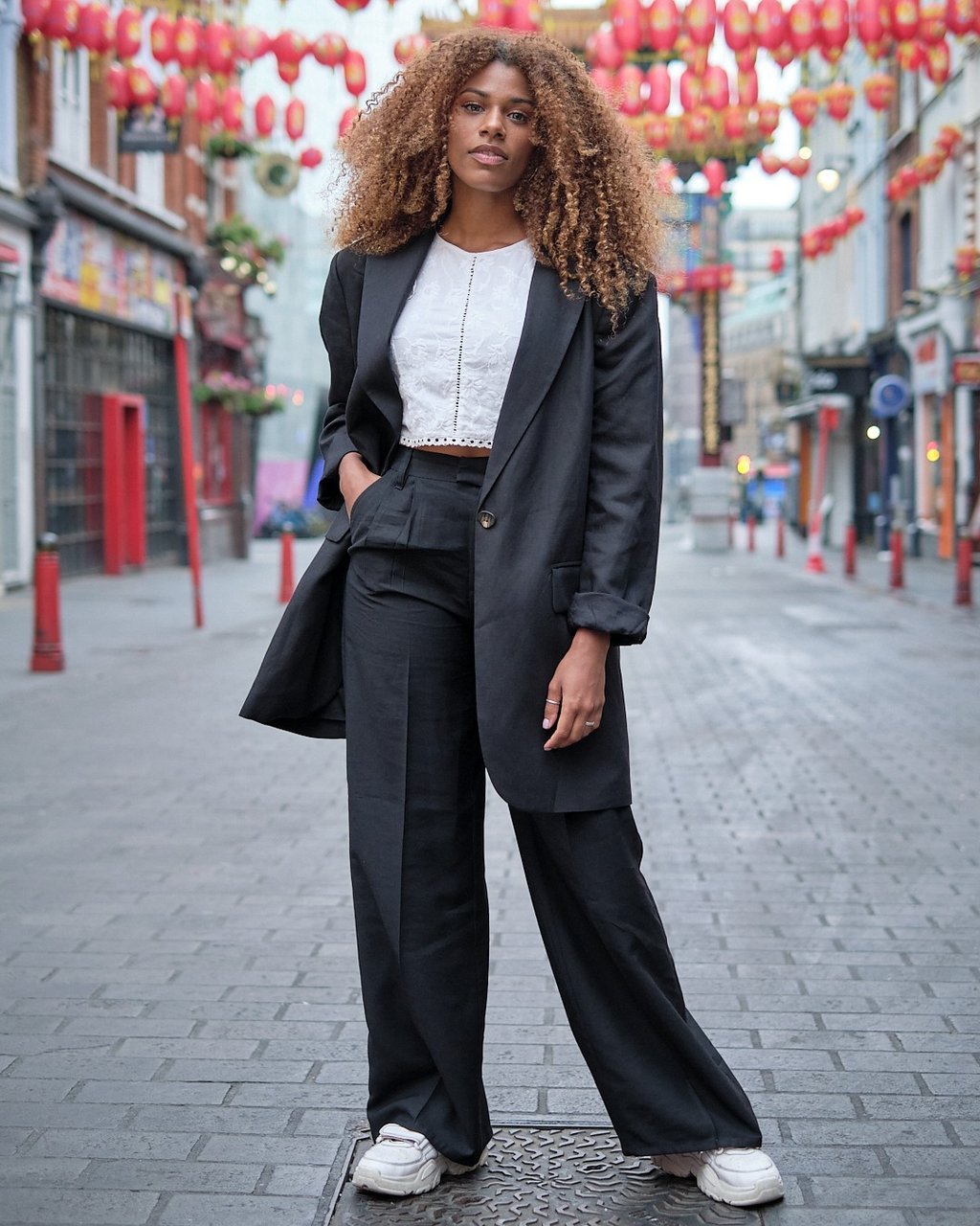 ensaio fotográfico urbano com mulher posando em rua turística da cidade