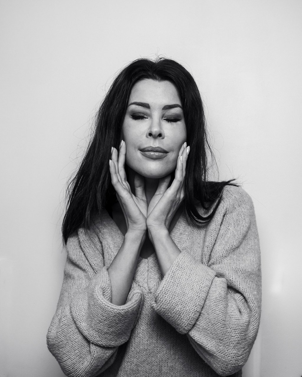 a woman with long hair and a sweater on