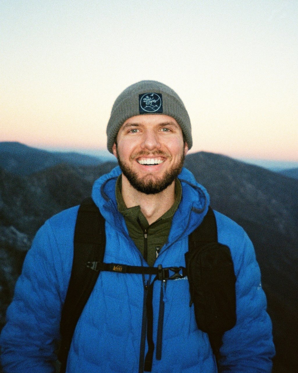 Nate Bowery standing in front of the Great Smoky Mountains during a winter hike