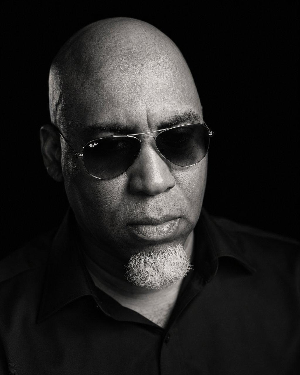 Lee A Jones host of Hindsight the Podcast in black and white wearing sunglasses