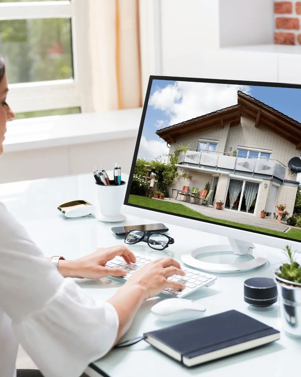 Modern home exterior and real estate listing materials on desk