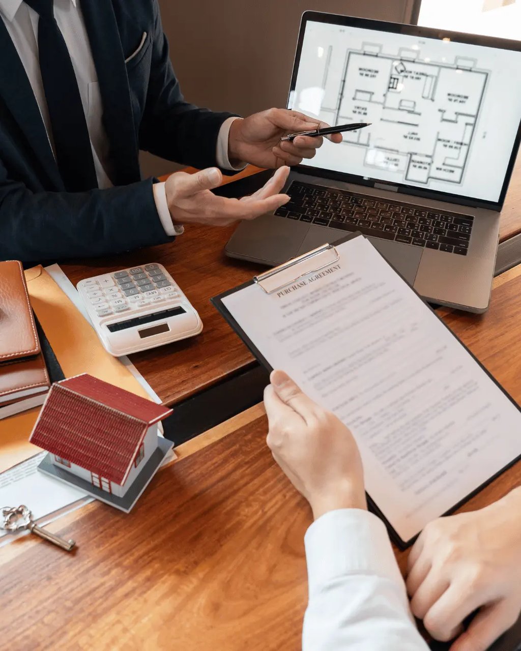 Home buyers reviewing a floor plan and contract
