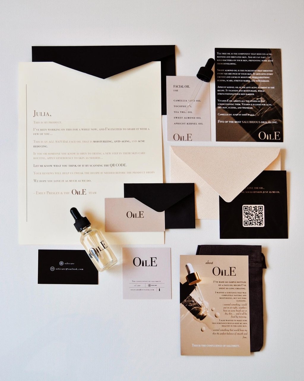 Luxury facial oil skincare packaging flat lay with minimalist bottles, stationery, and black envelopes.