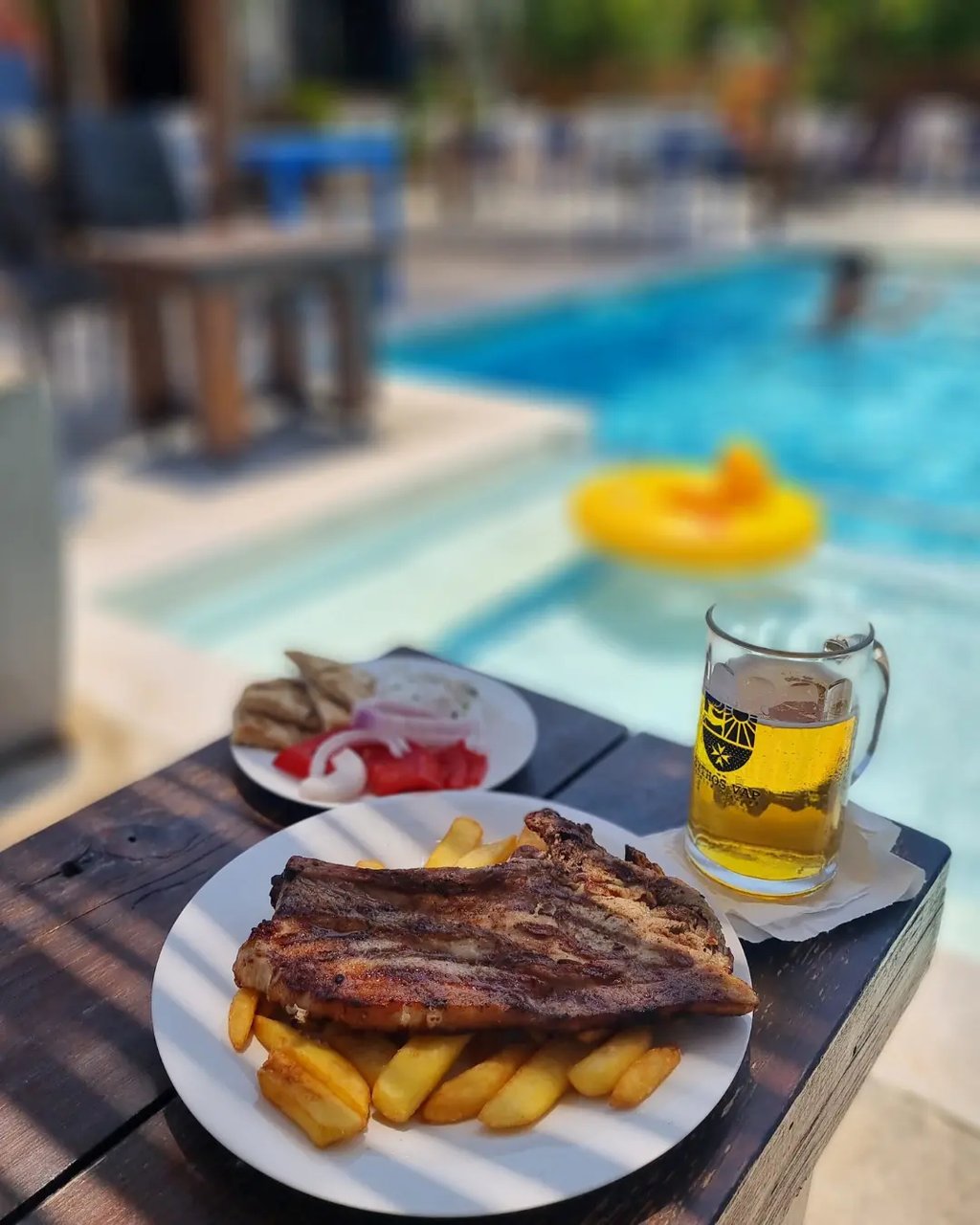 a plate of food and a beer on a table