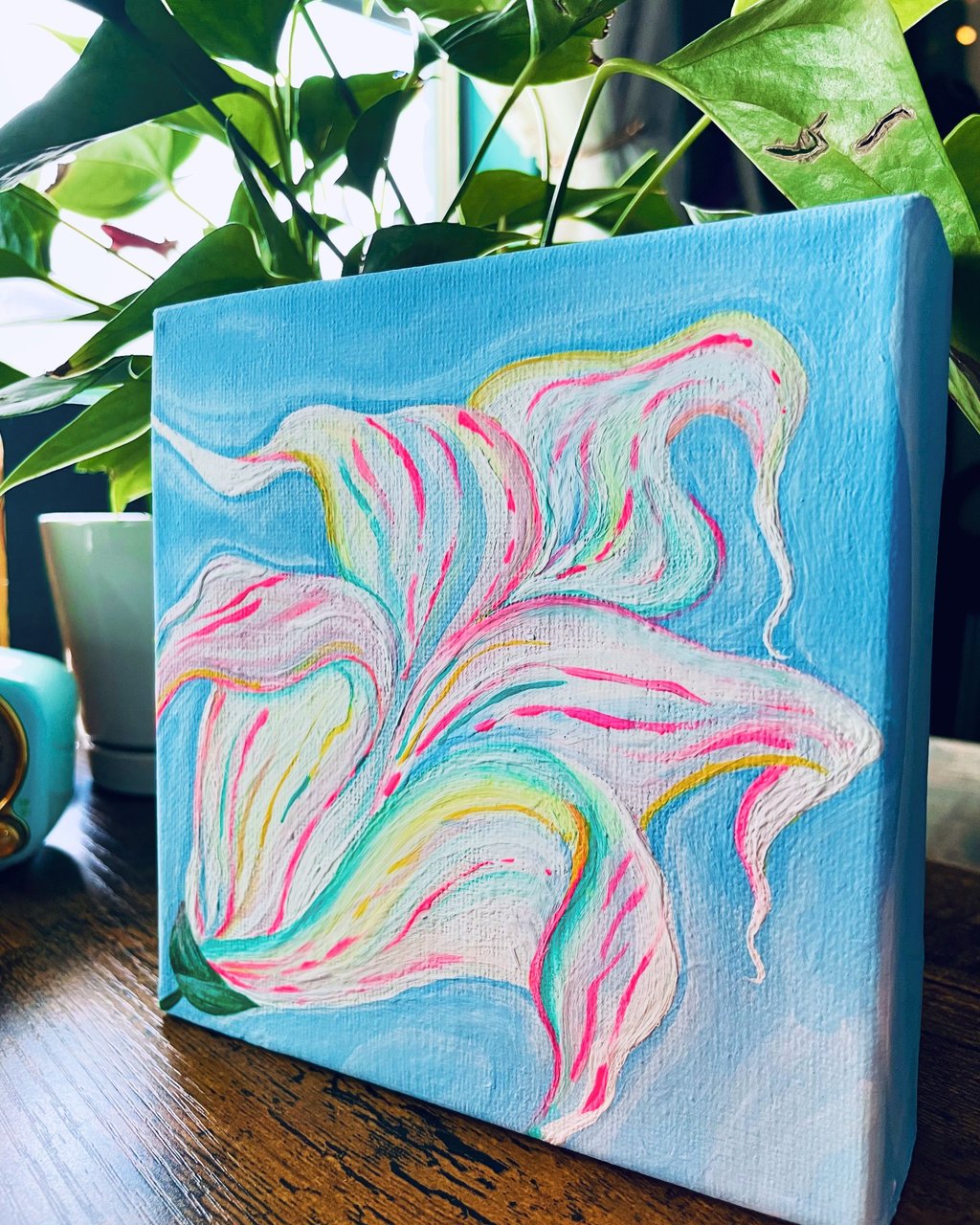 Abstract colorful image for a lily on blue background.  Pink, blue, white, green.