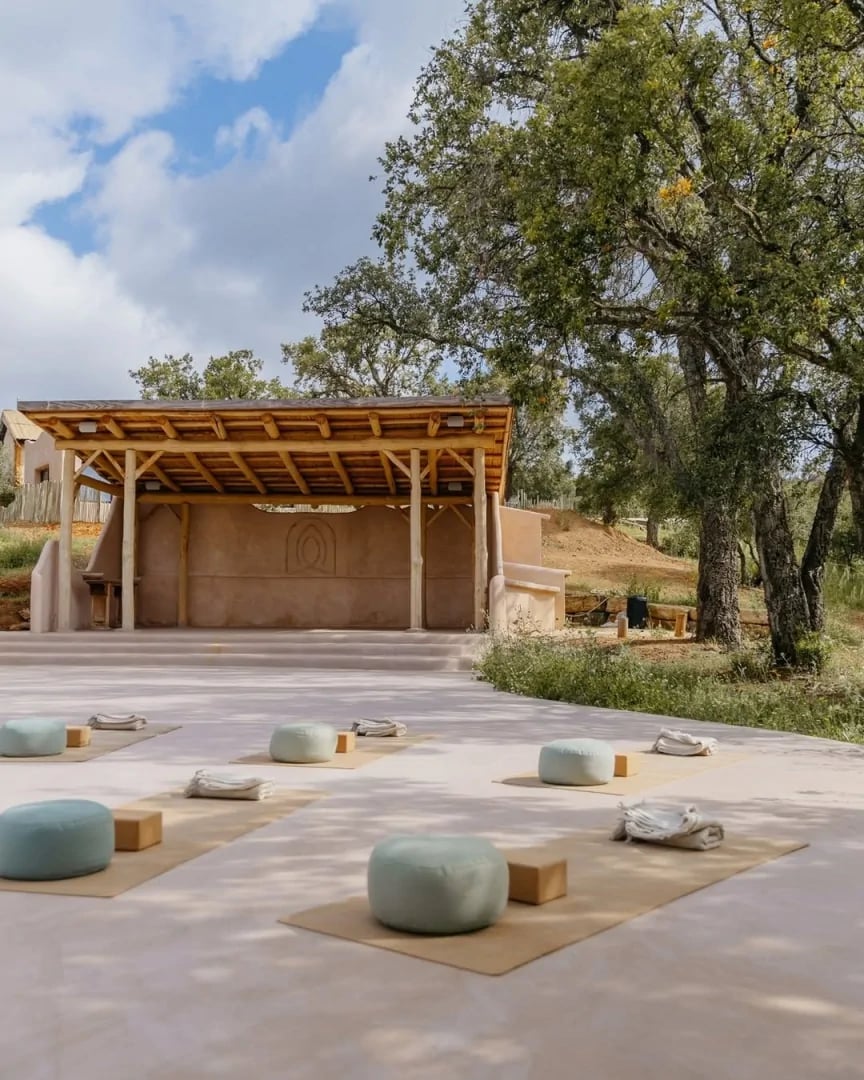 Outdoor yoga shala surrounded by trees and countryside