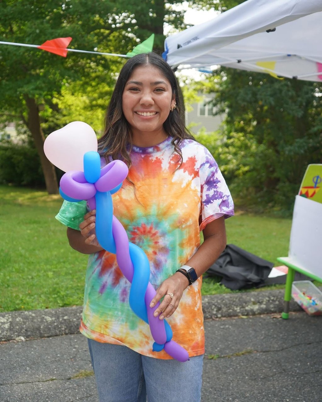 Kid posing with baloon staff