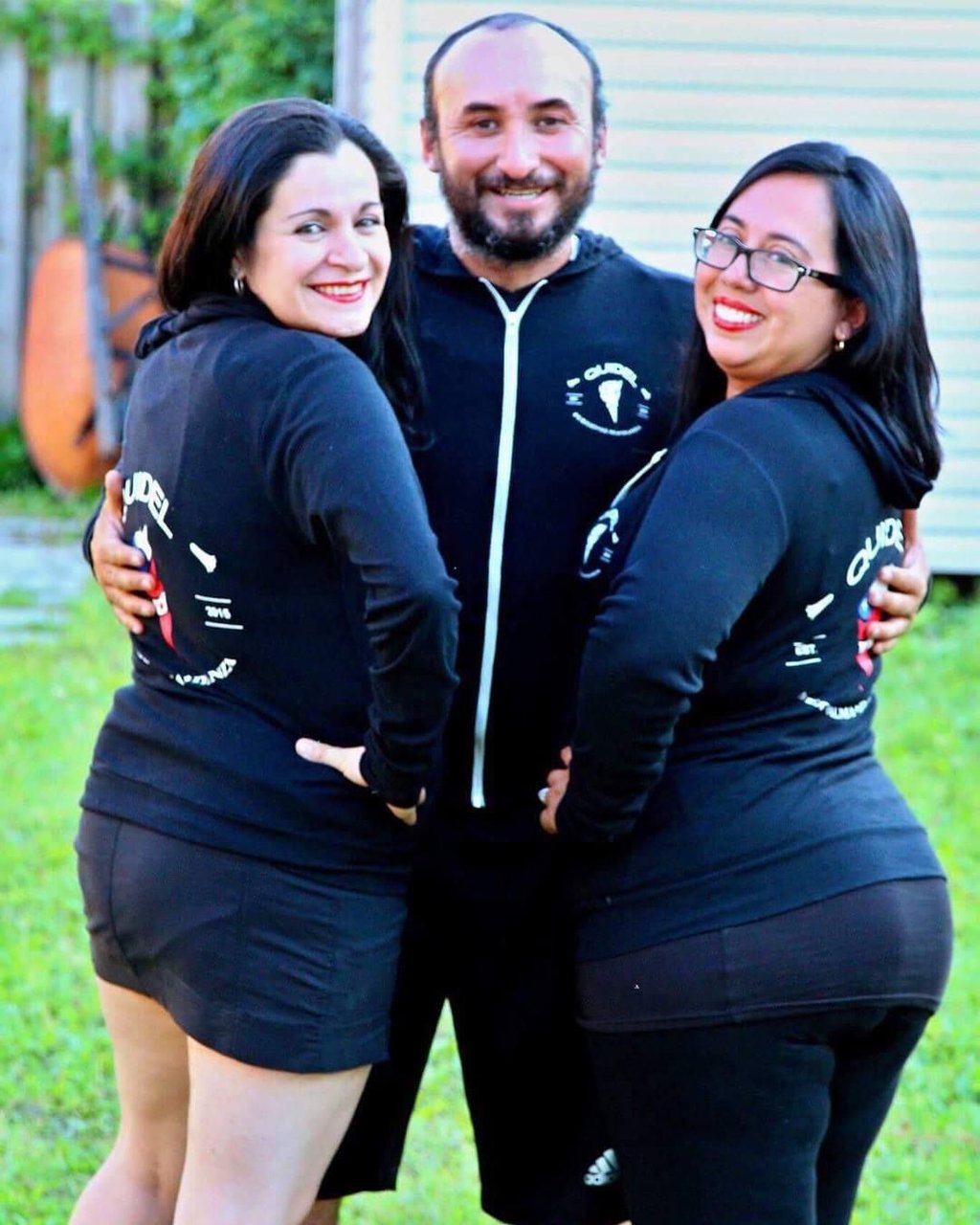 a man and woman in matching black outfits