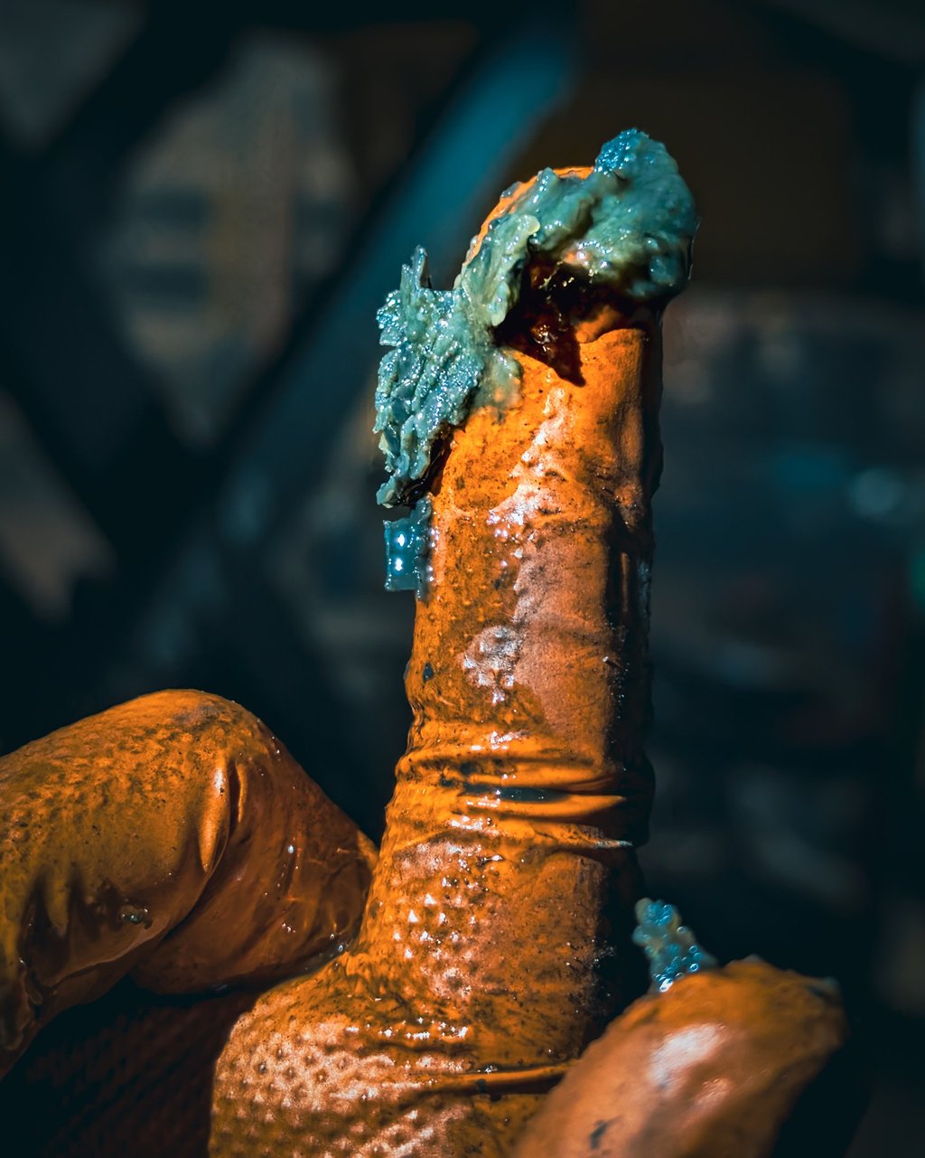 A gloved finger covered in thick Haldex fluid from a clogged Haldex filter