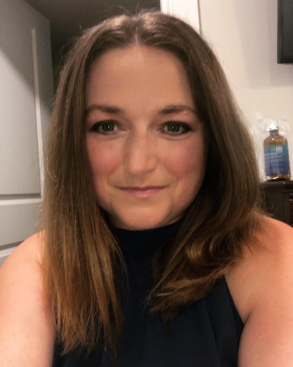 a woman with a blue dress and a black top