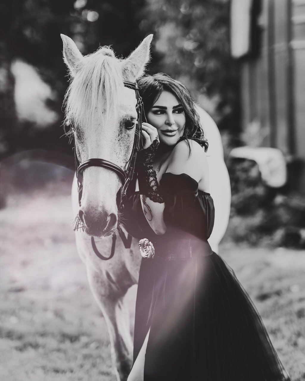 Black and white portrait of model with white horse, captured by Fred Art Studio.