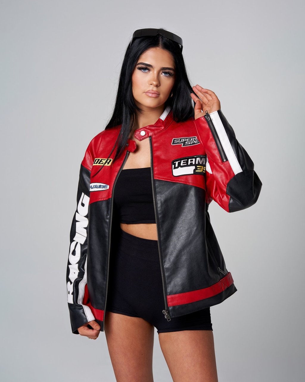A model in a black and red jacket and shorts