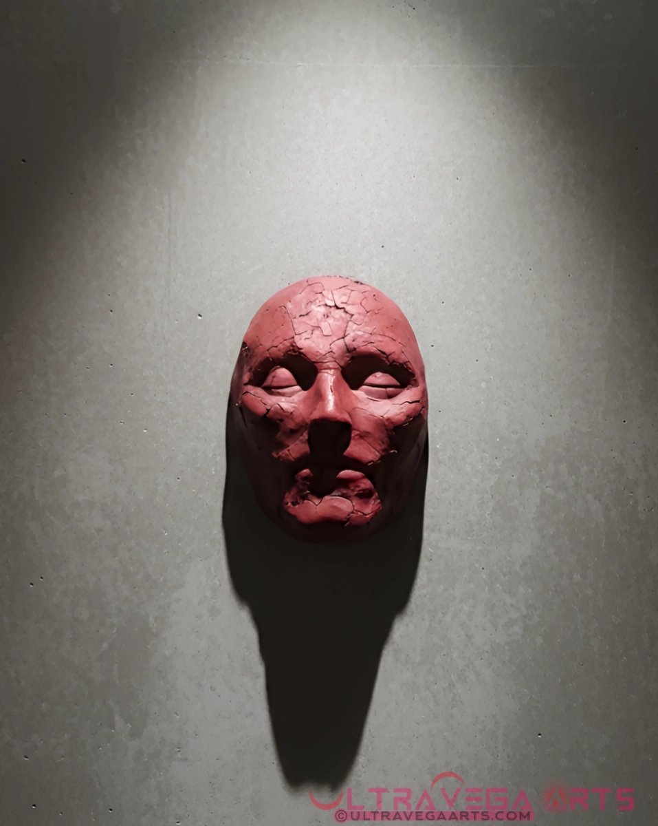 The Spirit Shell #3: Gallery View Handcrafted Paper Mache Mask Sculpture hanging on cement wall by Tom Gates