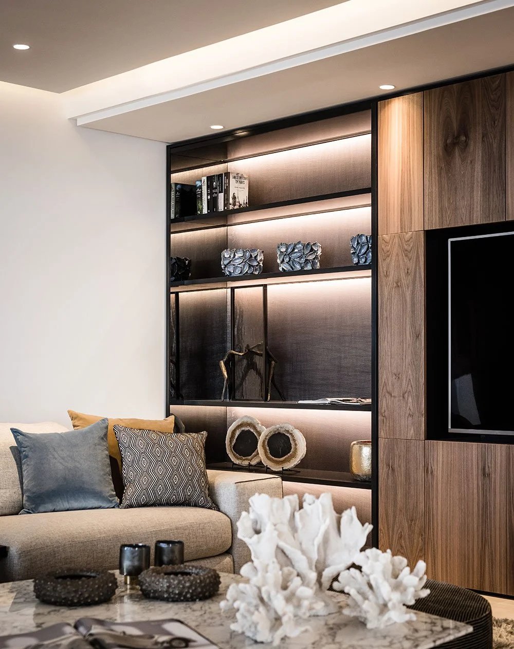 Living room detail with custom wood shelving and integrated TV wall