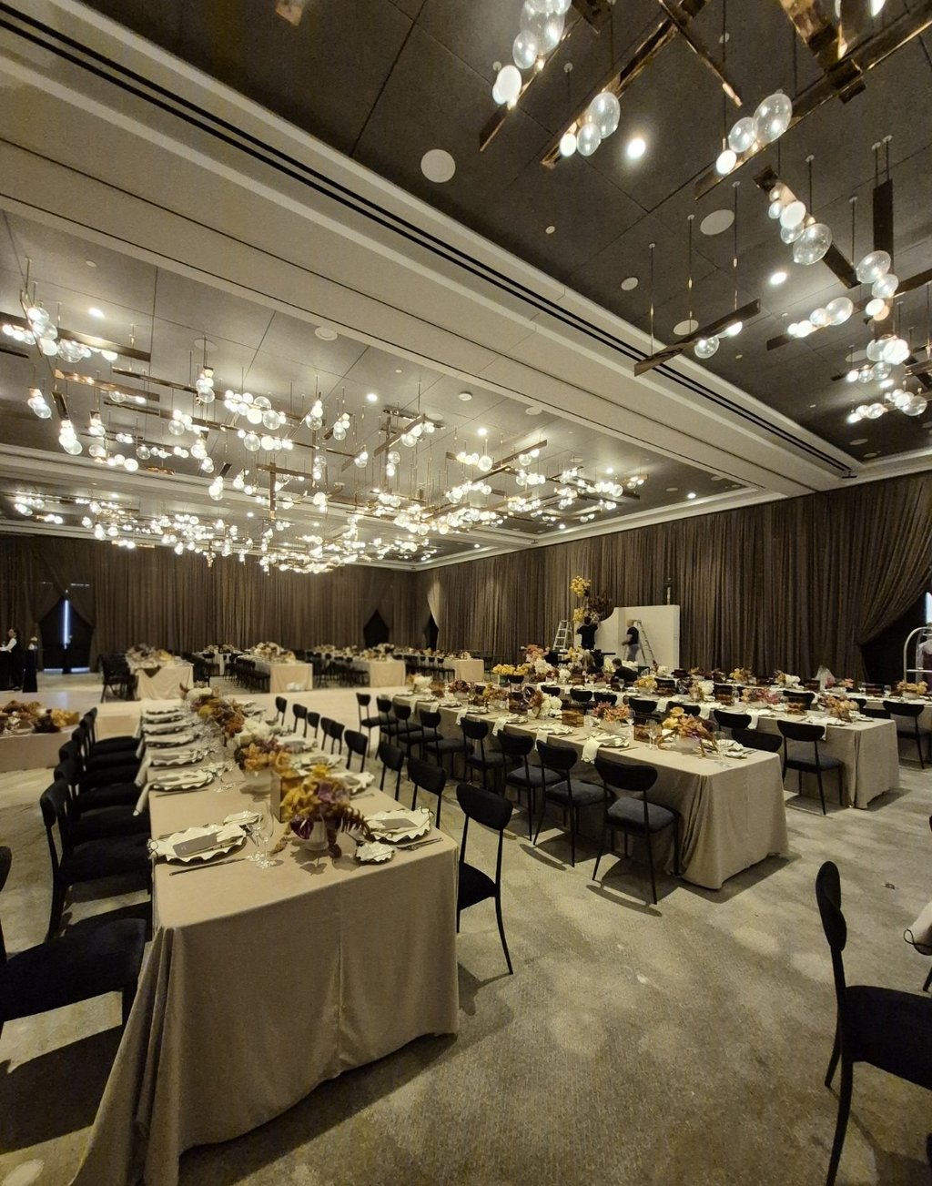 event space decorated with long table and flowers