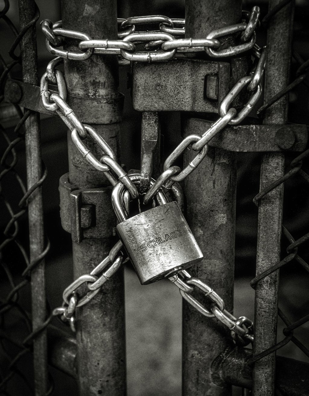 a gray lock on a steel fence