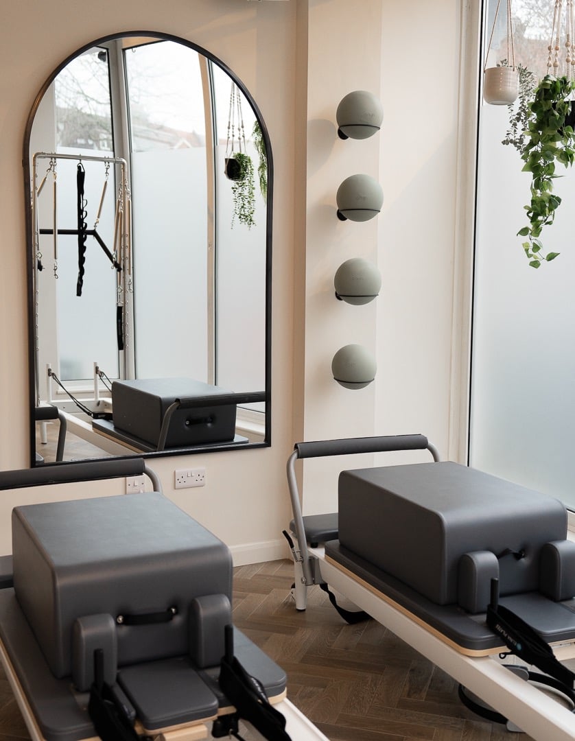 reformer pilates beds with pilates balls on the wall