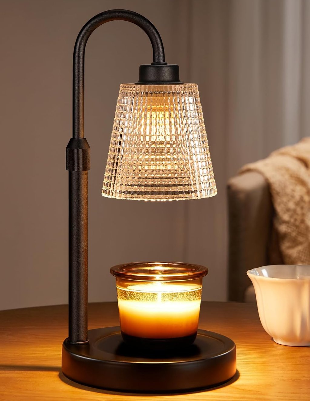 Electric candle warmer lamp with an adjustable black stand and a crystal glass shade heating a jar candle.