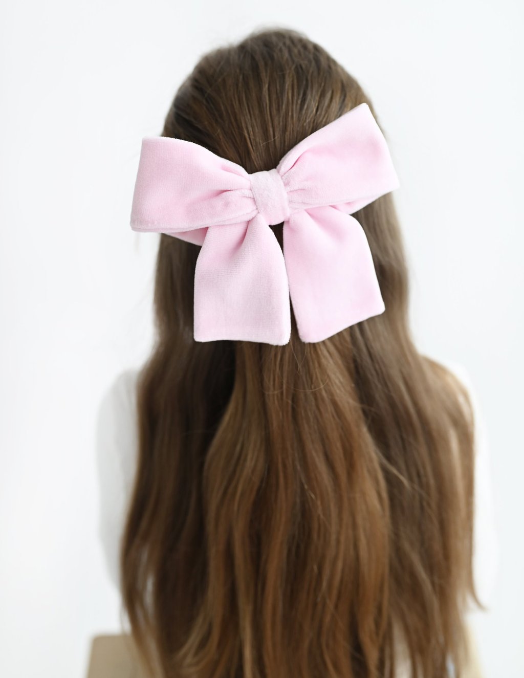 a woman with a pink bow tie on her hair