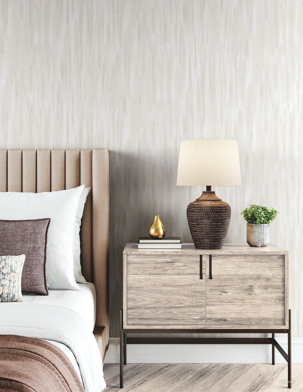 Modern bedroom with a channel-tufted headboard, wooden nightstand, and textured wallpaper background.