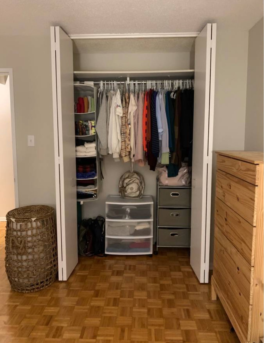 An "after" picture of a bedroom closet neatly organized.