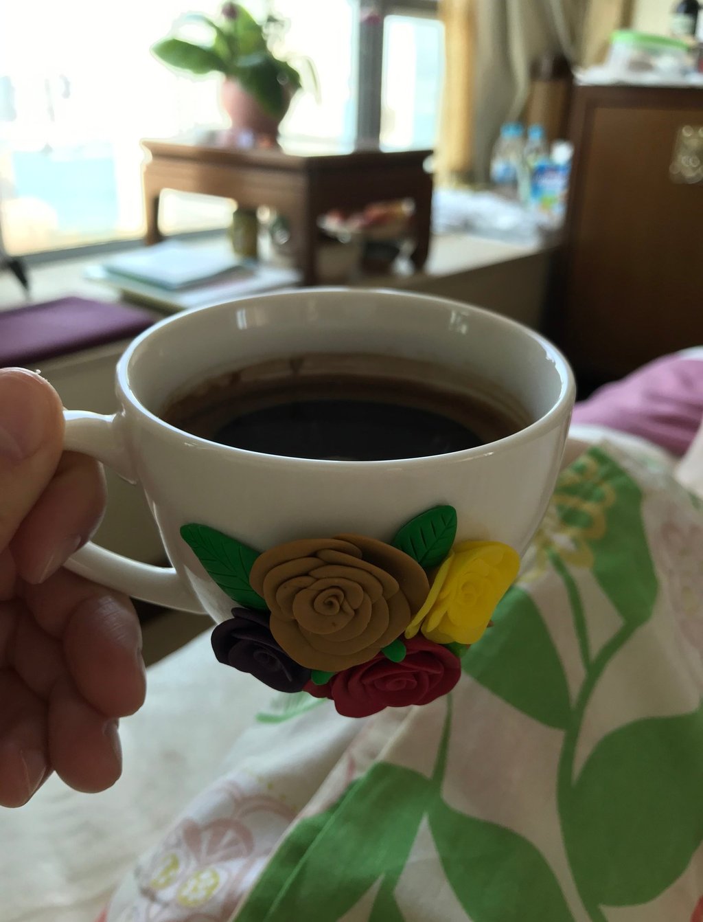  holding a cup of coffee