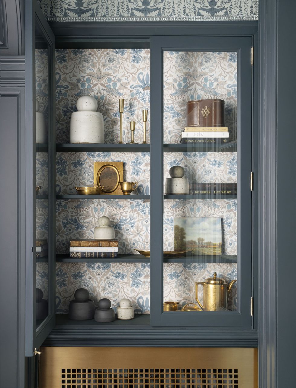 a cabinet with a glass door and a shelf with dishes