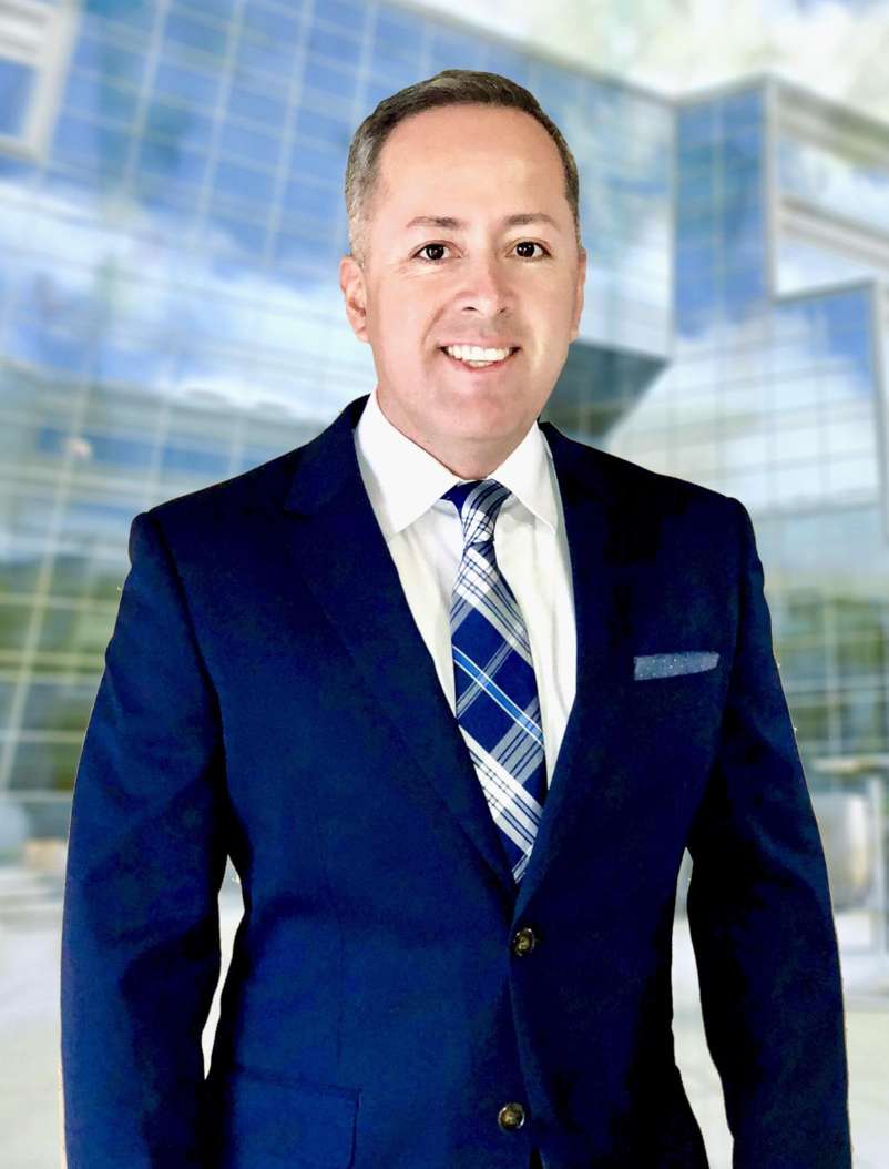 a man in a suit and tie smiling