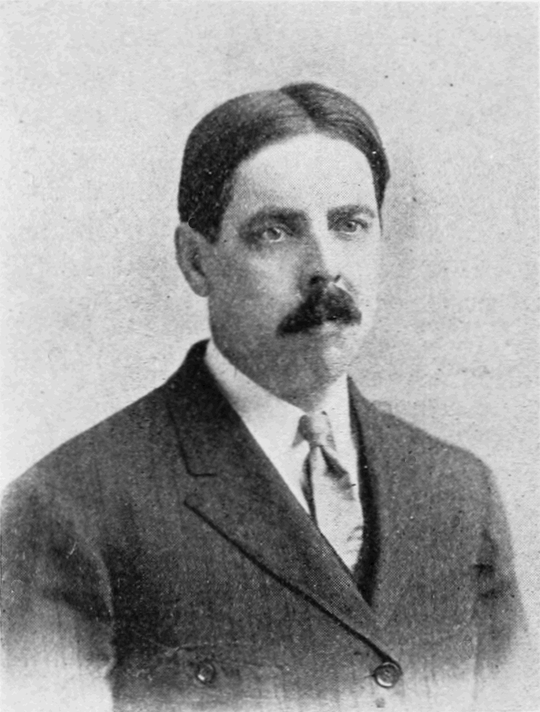 um homem de terno e gravata com bigode