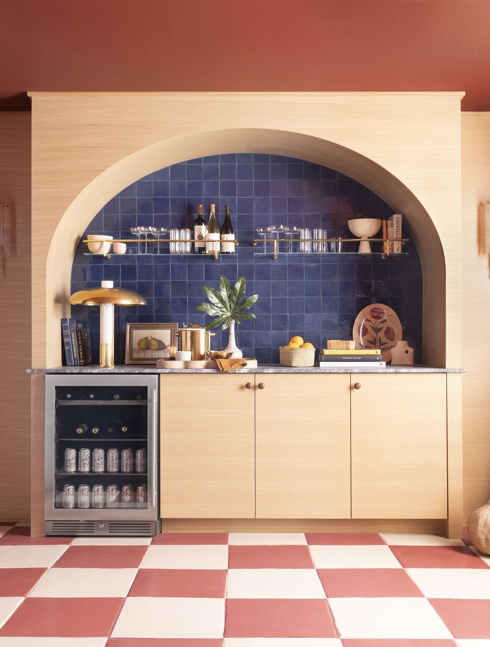 a kitchen with a blue tile floor and a red tile floor