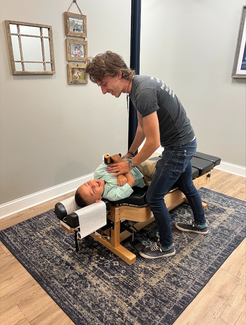 Child receiving chiropractic adjustment for sensory processing issues