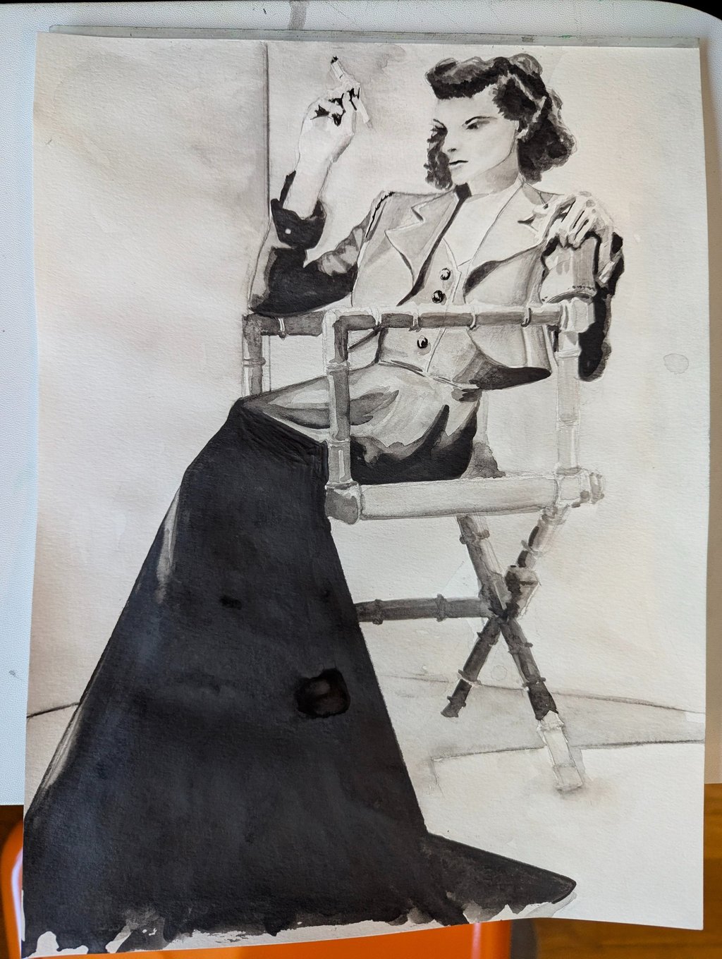 A graphite drawing of a classic 30s photo of Katherine Hepburn sitting in a director's chair rendered by Kathy LaFollett.