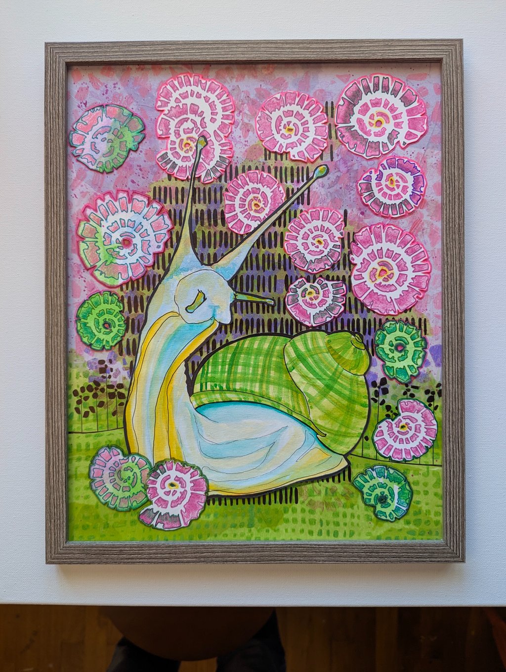 Multi-media artwork in pinks, lime greens and blues in mid mod style of a snail and flowers by Kathy LaFollett.