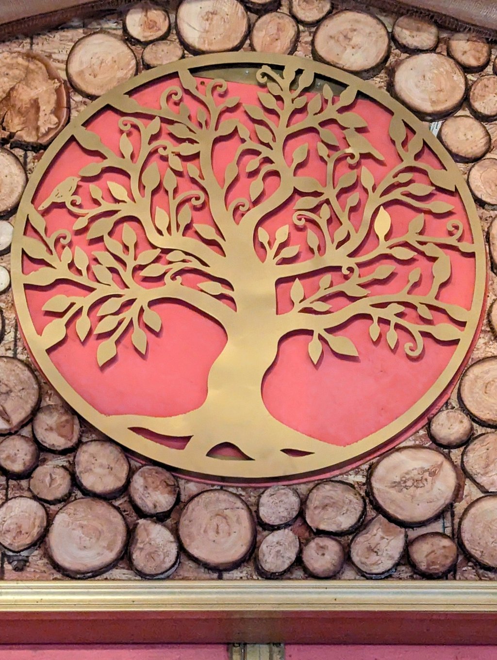 Golden Tree of Life metal wall art decor mounted on a rustic wood log slice background.