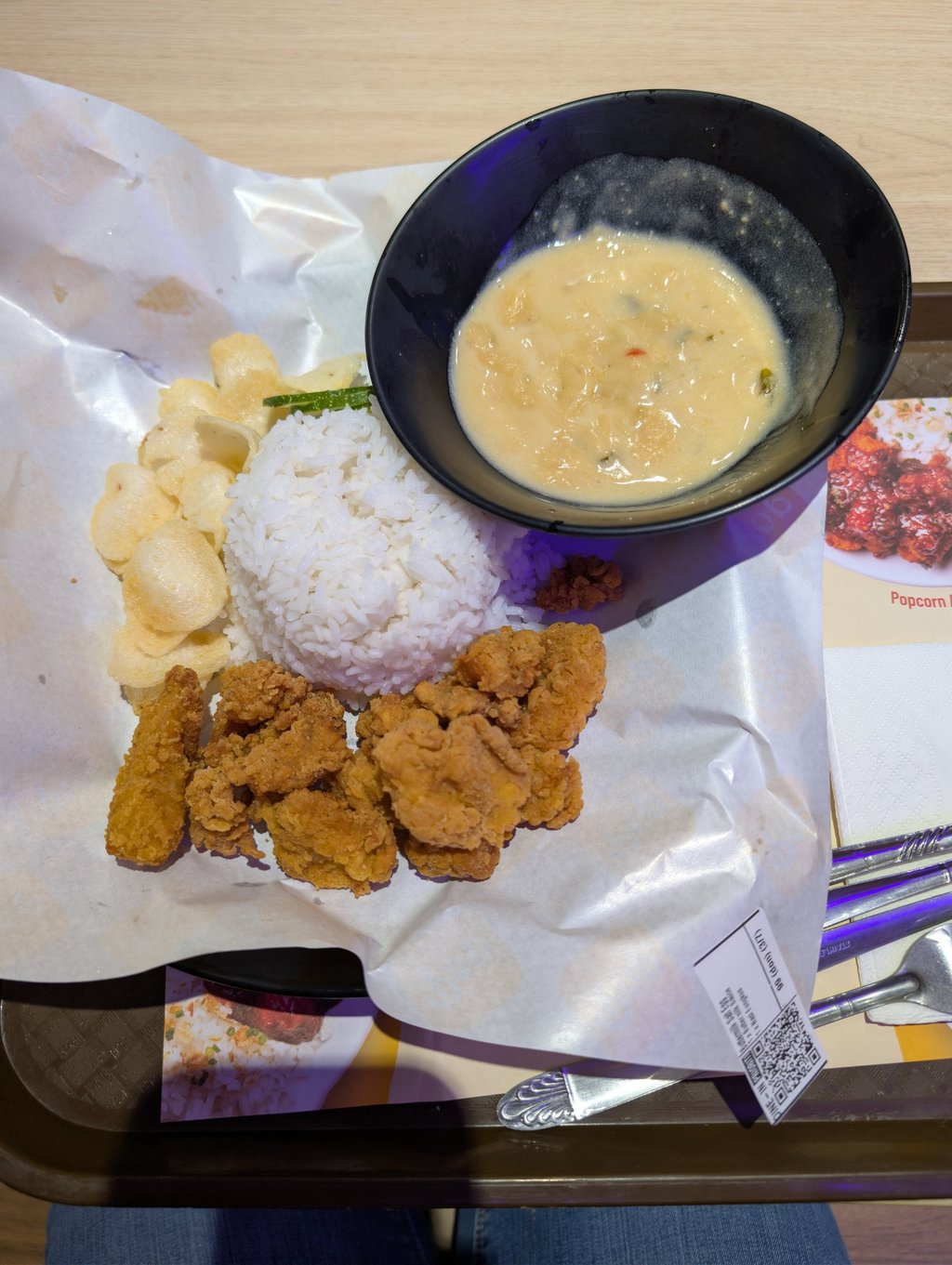 Crispy salted egg chicken popcorn served with steamed white rice, crackers, and creamy sauce.