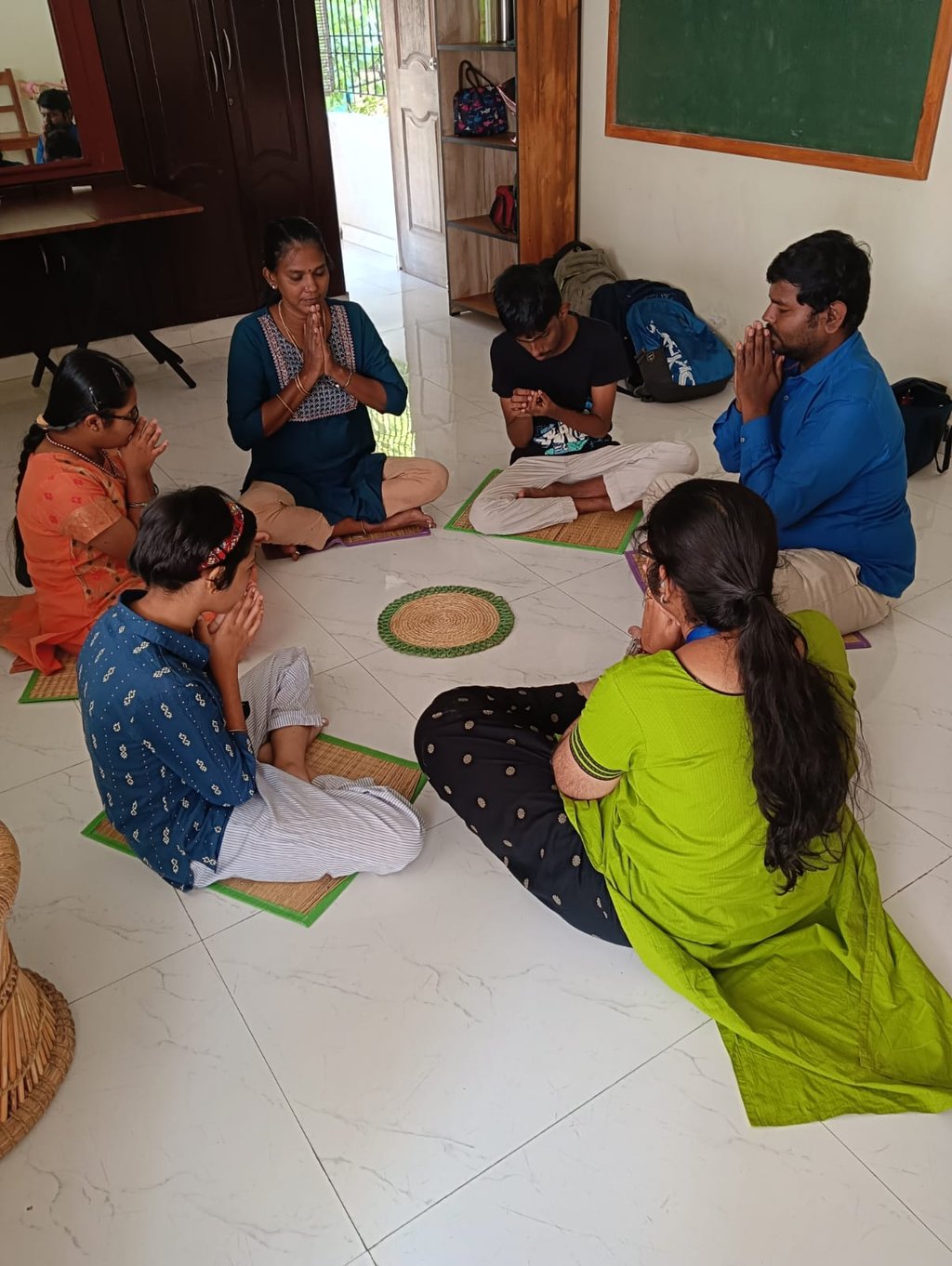 In a respectful and loving environment children are in a circle and doing morning prayer